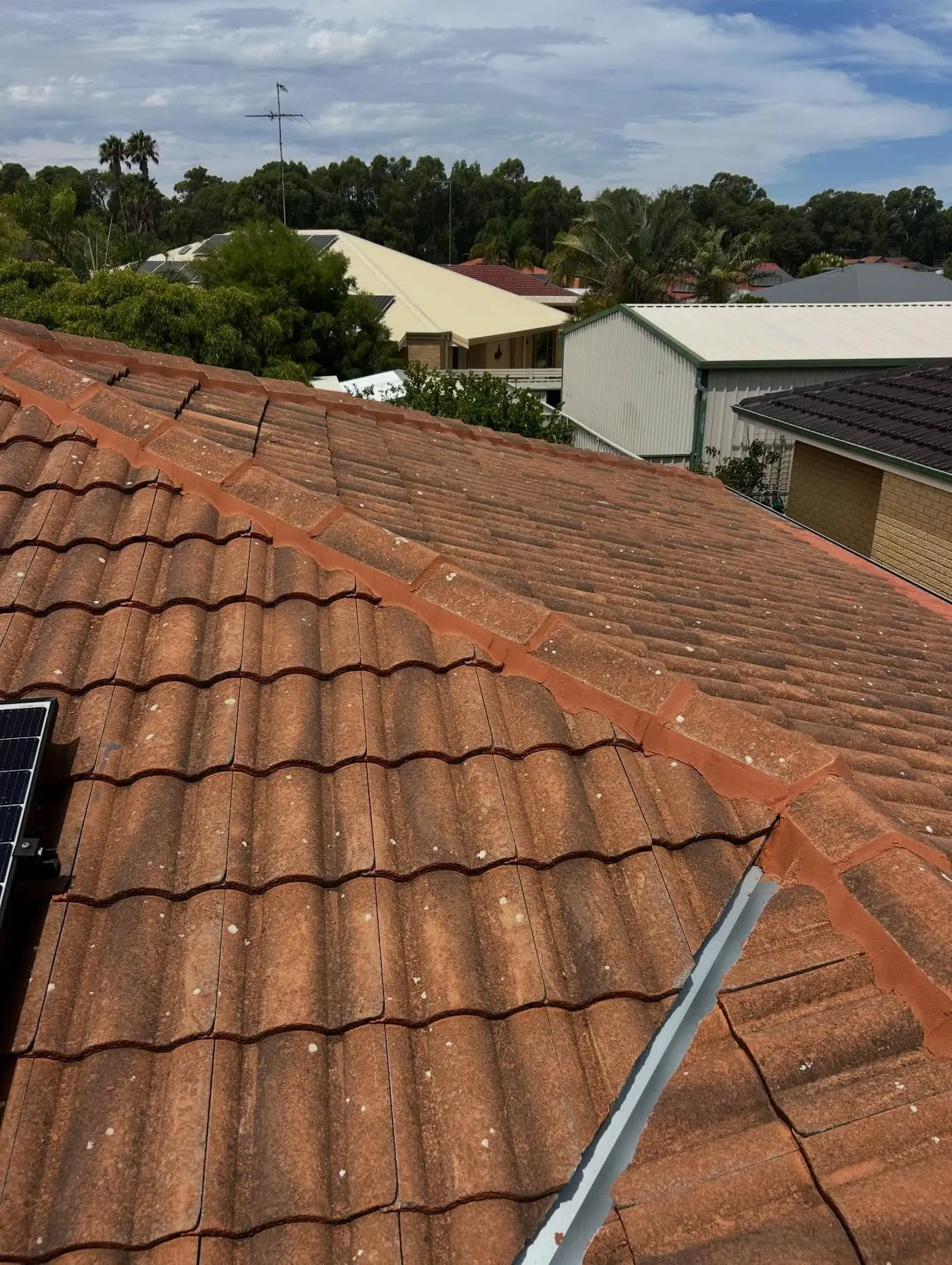 Terracotta roof valley above a suburban street