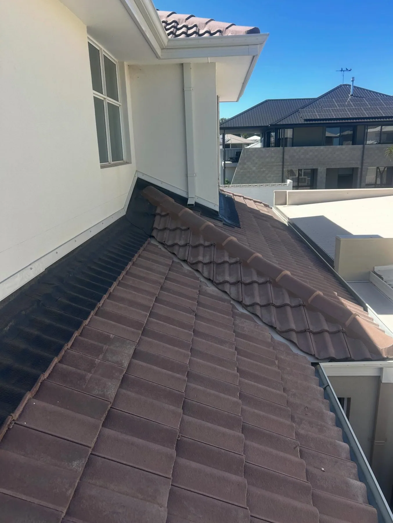 Finished valley detail between brown tiled roof sections