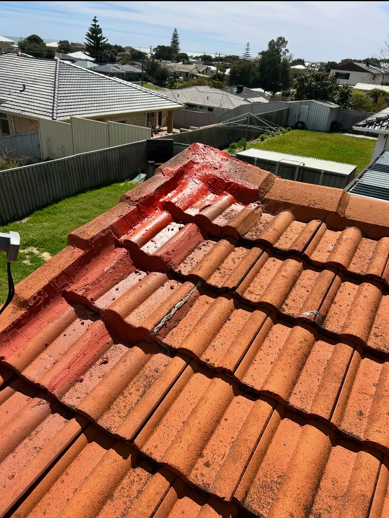 Finished pointing around a terracotta tiled ridge junction
